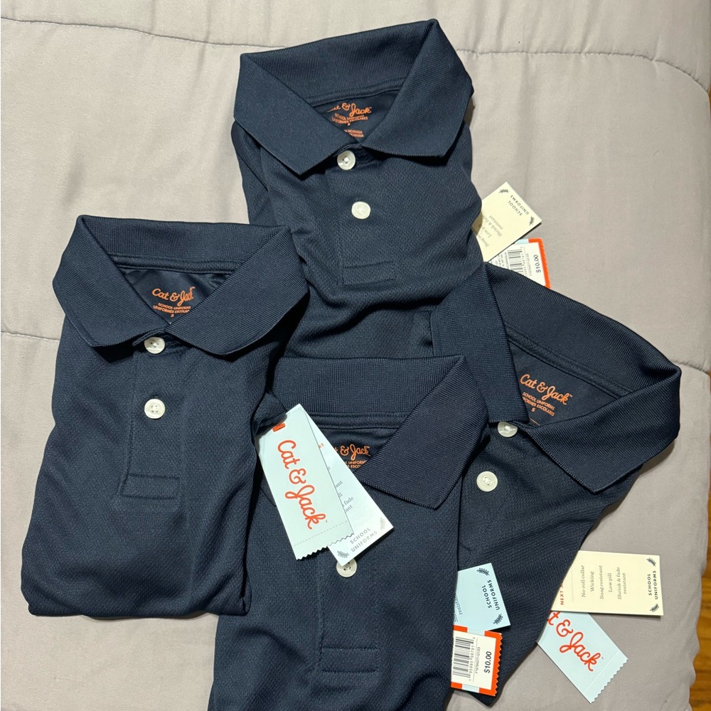 Set of 4 navy short sleeve performance uniform polo shirt.